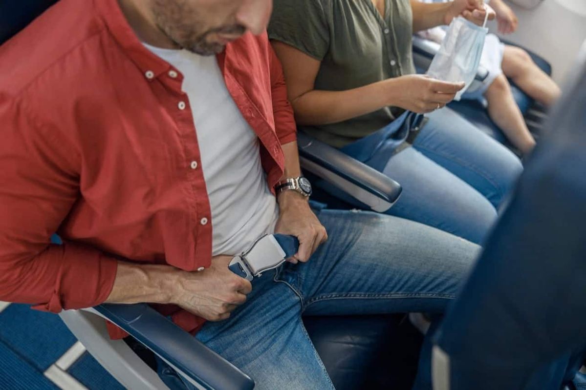 Airplane seat belt extender use